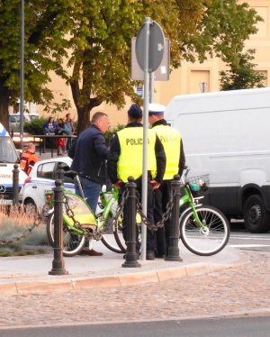 Policjanci rozmawiają i sprawdzają stan trzeźwości rowerzysty